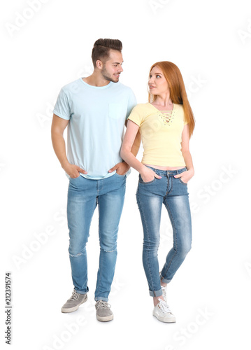 Young couple in stylish jeans on white background