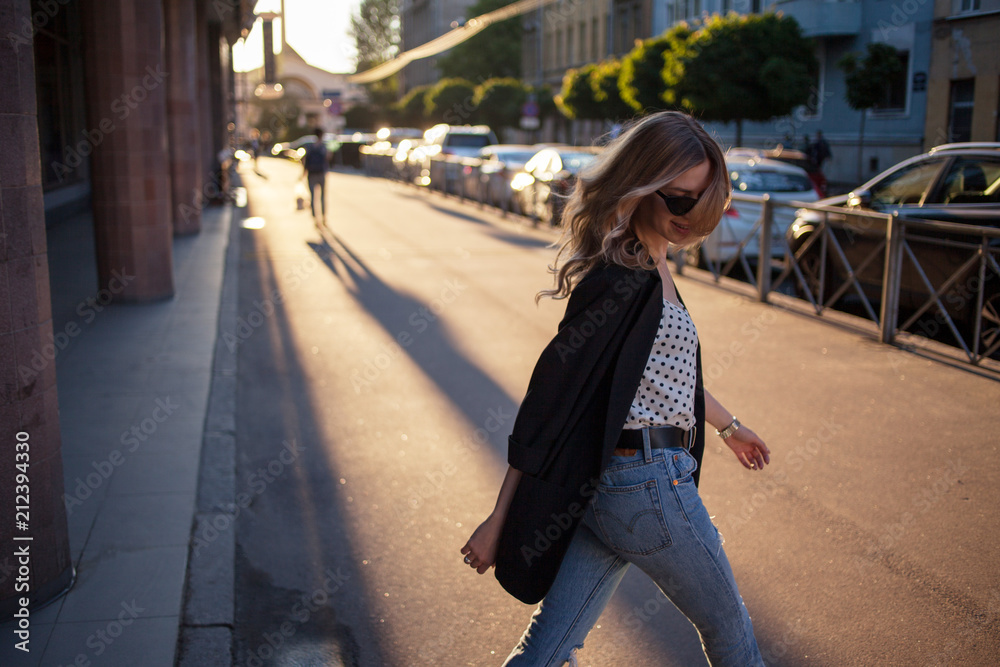 Fototapeta premium Happy young girl walking around town, portrait on the city background.