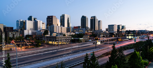 Early Morning Traffic Passes in front Of Buildings Reflecting Sunrise Light in Bellevue, Washington photo