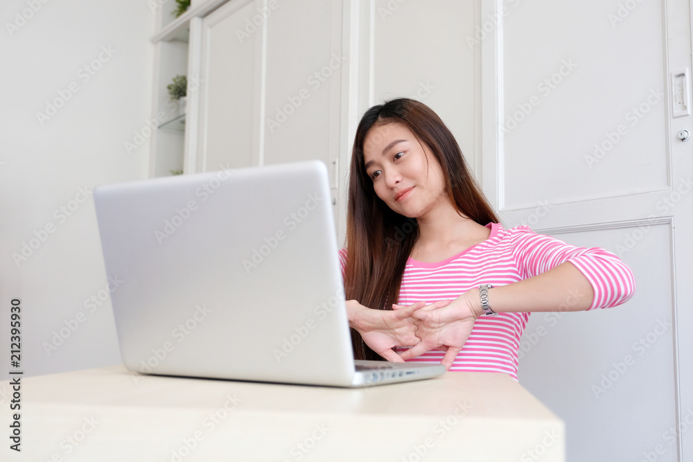 Young asian woman stretching body for relaxing while working with laptop computer at home office, working from home Young asian woman stretching body for relaxing while working with laptop computer at home office, working from home