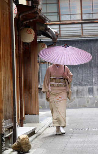 A Japanese lady out in traditional kimono walking in Gion, Kyoto, Japan.