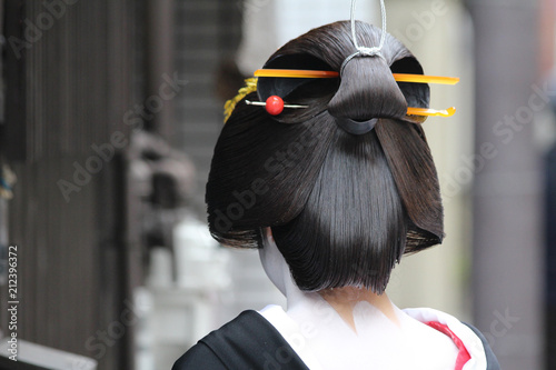 Slika na platnu A traditional geisha out and about walking in Gion Kyoto Japan.