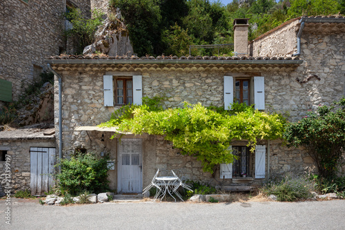 Stone house with white shutters in Brantes, Provence, France