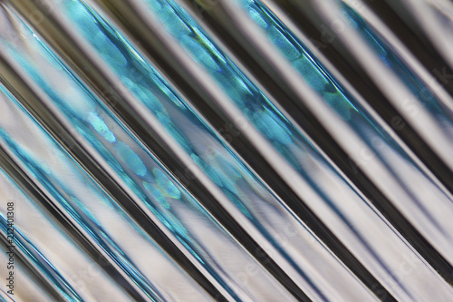 Metallic looking macro abstract background featuring defocused lead crystal glass with diagonal lines pattern
