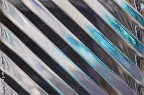 Metallic looking macro abstract background featuring defocused lead crystal glass with diagonal lines pattern