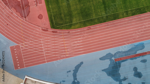 Aerial view of track and field stadium on a cloudy day after rain