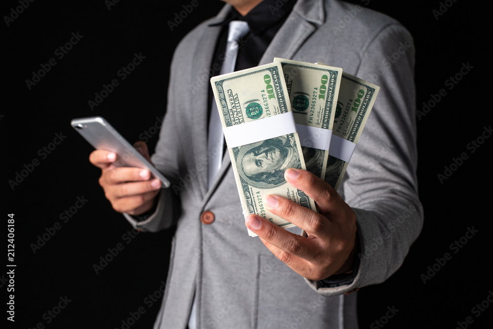 Man holding Money in hand at Black Background, Man receive a lot Money from  Trading, Business Success Concept. Stock Photo | Adobe Stock