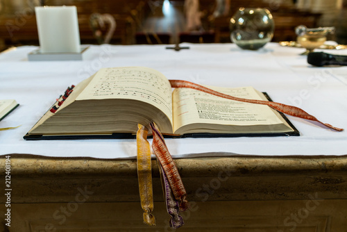 Valokuva praying book on the altar in a church before wedding focused on the bible