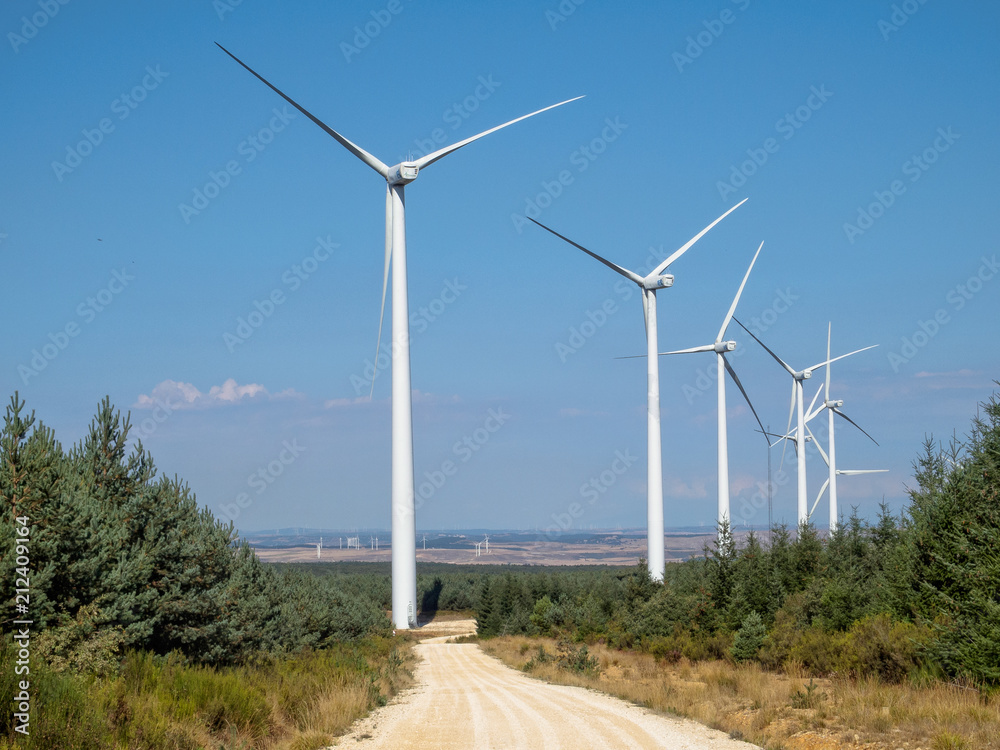 Wind turbines above the Peroja stream - St. Juan de Ortega, Castile and León, Spain Wind turbines above the Peroja stream - St. Juan de Ortega, Castile and León, Spain