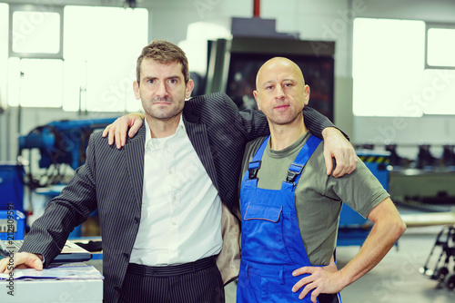 boss and worker on work bench- hugging