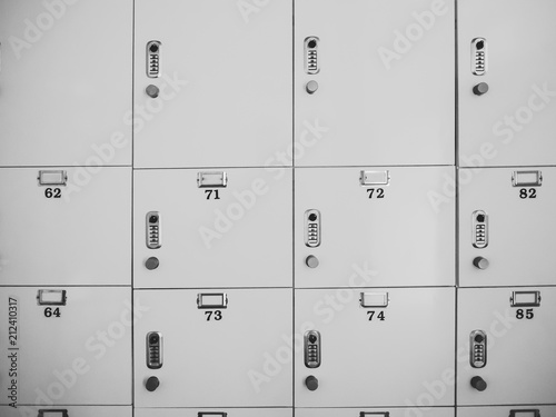 Rows of gray small lock boxes in lockers room.