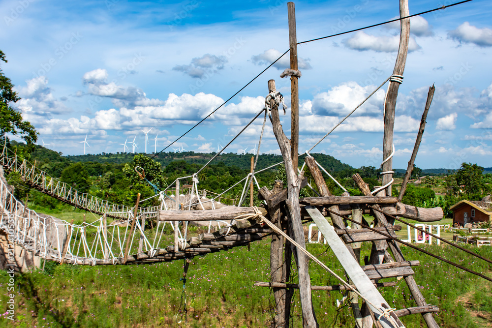 Fototapeta premium Wooden bridge on the rocks and a beautiful sky at Chaiyaphum in Thailand.
