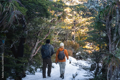 People hiking in a snowy forest. kahurangi national park, New Zealand.