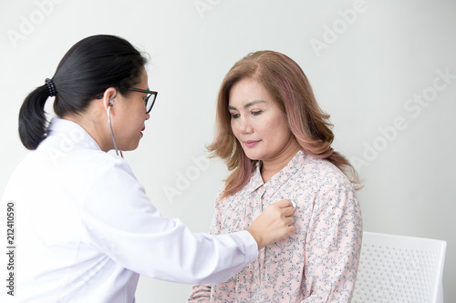 Doctor examining a woman in a hospital. Stethoscope doctor. Close Up. Asian people.
