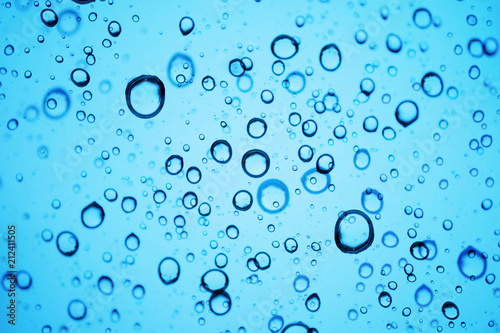 Oxygen Bubbles in Water or Rain Drops on Glass Texture Background. Blue Tone