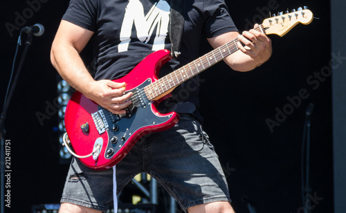 Guitarist  play electricity guitar on concert stage