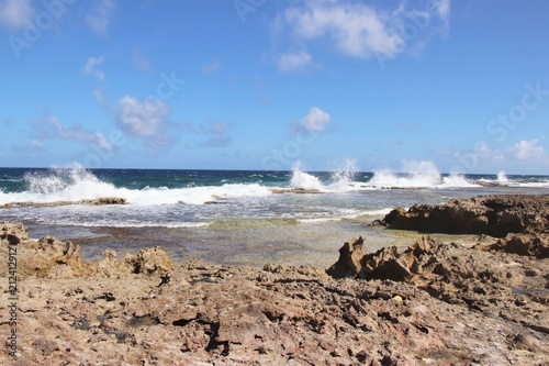 Beach area with a rocky shoreline and waves breaking
