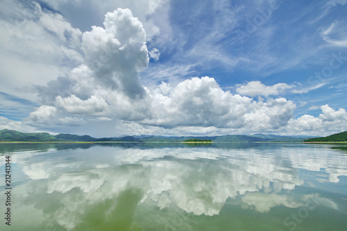 Fototapeta Naklejka Na Ścianę i Meble -  The Islands and mountains on reservior in dam. On the day of clouds and cloud reflection in the beautiful water of  KaengKrachan National Park.