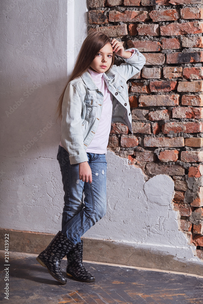 child posing in a stylish, urban, casual clothes. fashion little