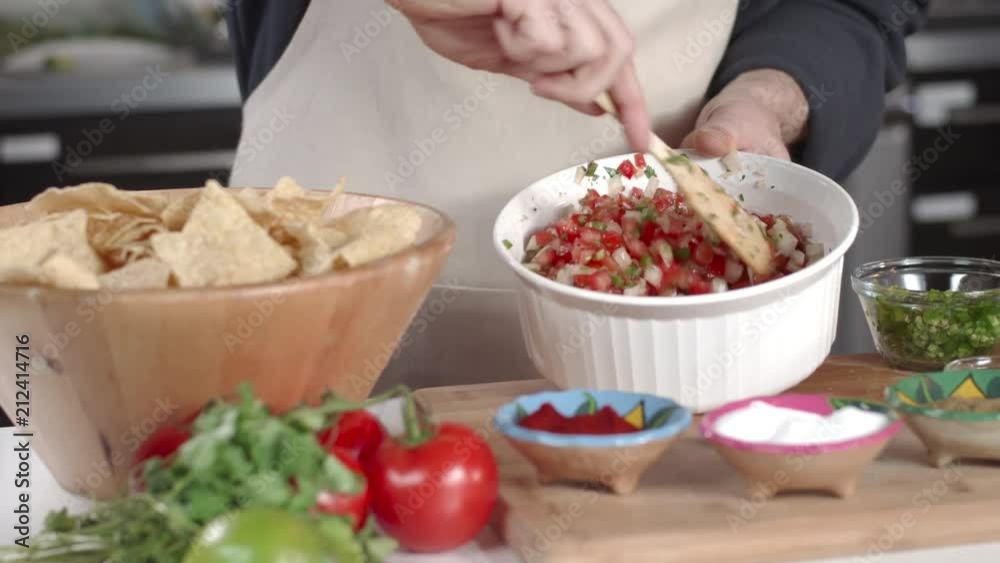 Slow-mo tracking shot of chef mixing ingredients in large white bowl Slow-mo tracking shot of chef mixing ingredients in large white bowl