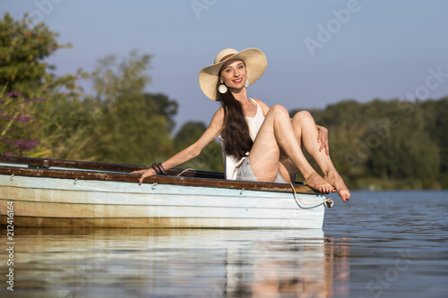 Attractive young woman with long brunette hair on a boat