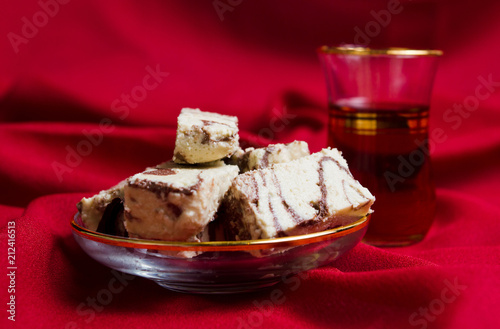 Halva with cacao and tea on a plate photo