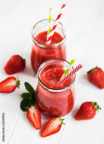 Jars with strawberry smoothie