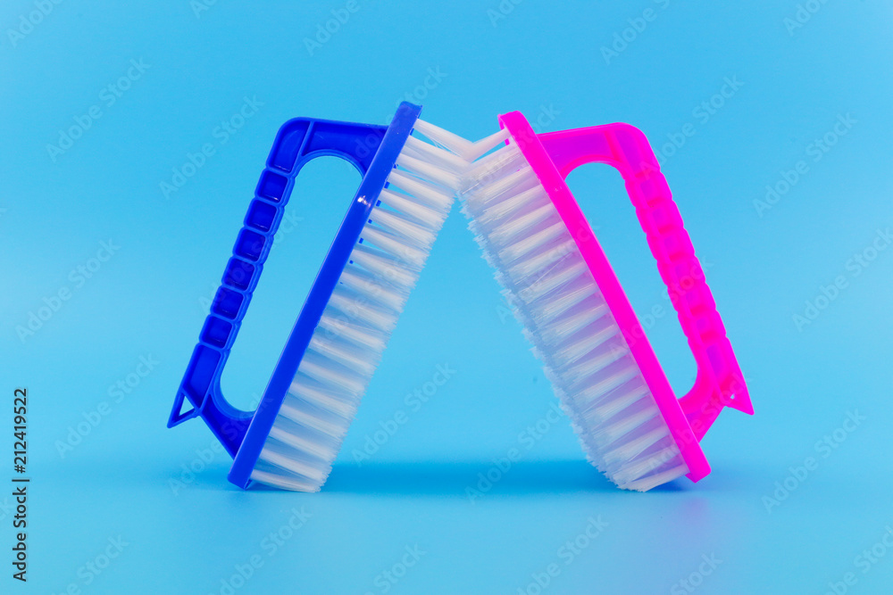 Plastic Scrub Brush on a Blue background Plastic Scrub Brush on a Blue background