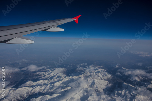 airfoil in blue sky across mountains