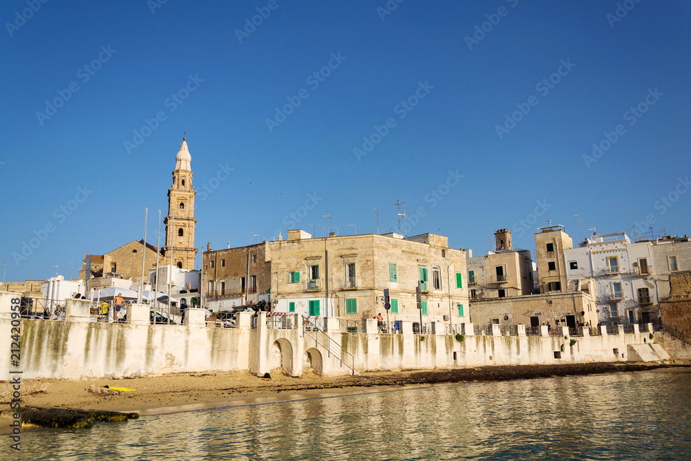 Sunrise on beach Porta Vecchia near Cathedral in Monopoli, Apulia, Bari province, Italy