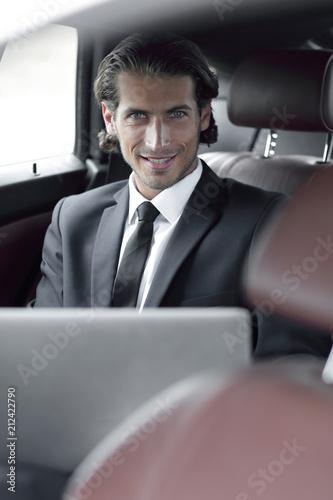 man working on laptop while sitting in the car © ASDF