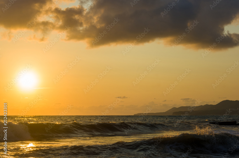 Fototapeta premium Amazing sea sunset, the sun, waves, clouds
