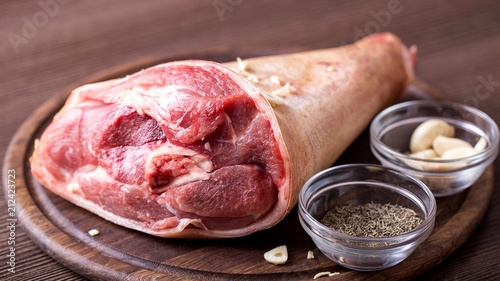 Canvas Print Raw pork knuckle on  cutting board.