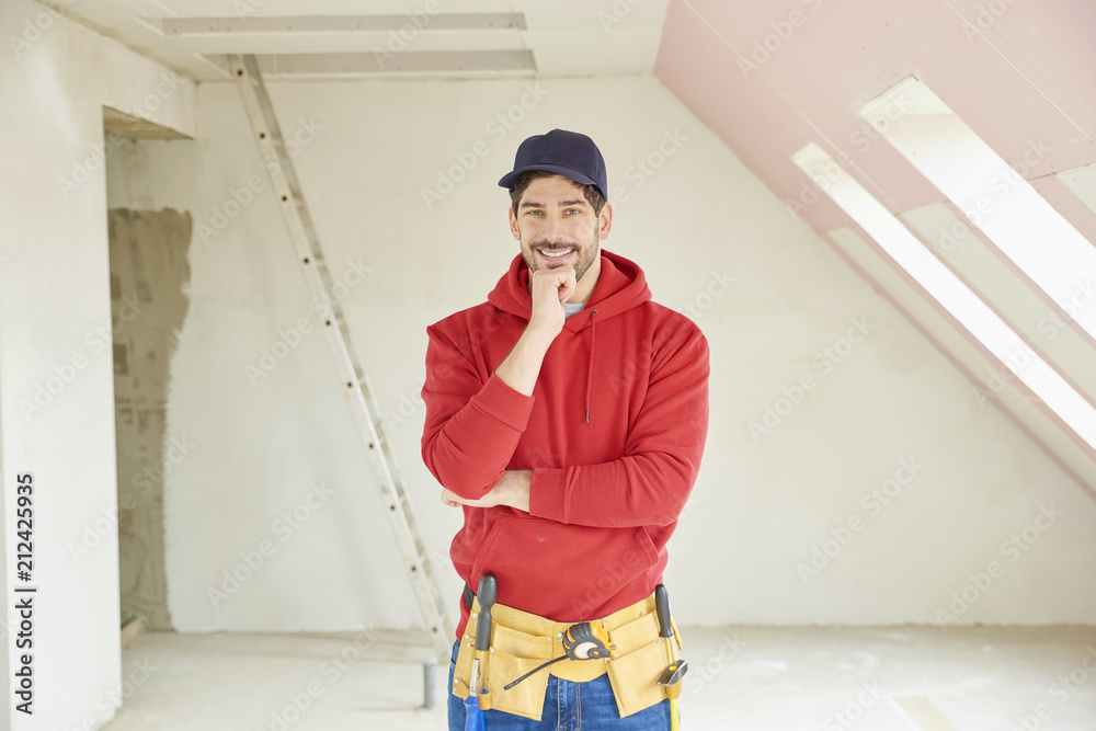 Handsome young repairman portrait at construction site