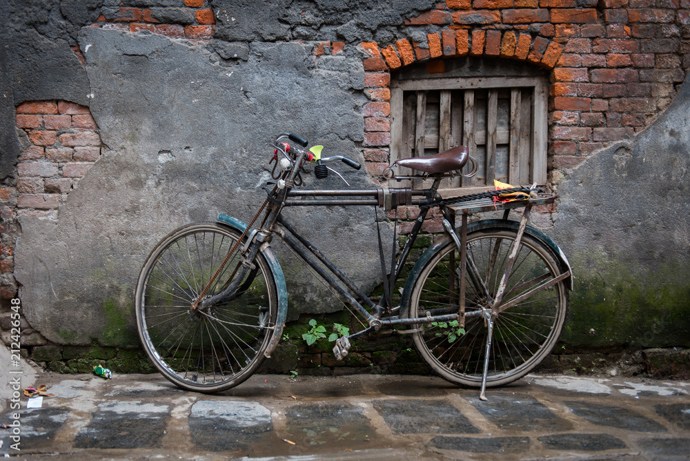 Old bicycle on its stand by a decaying old wall, Ason Tol, Kathmandu, Nepal