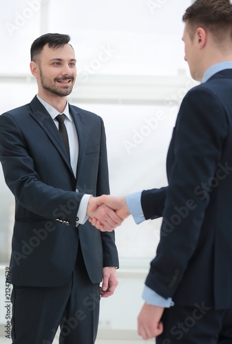 handshake financial partners in the corridor of the office