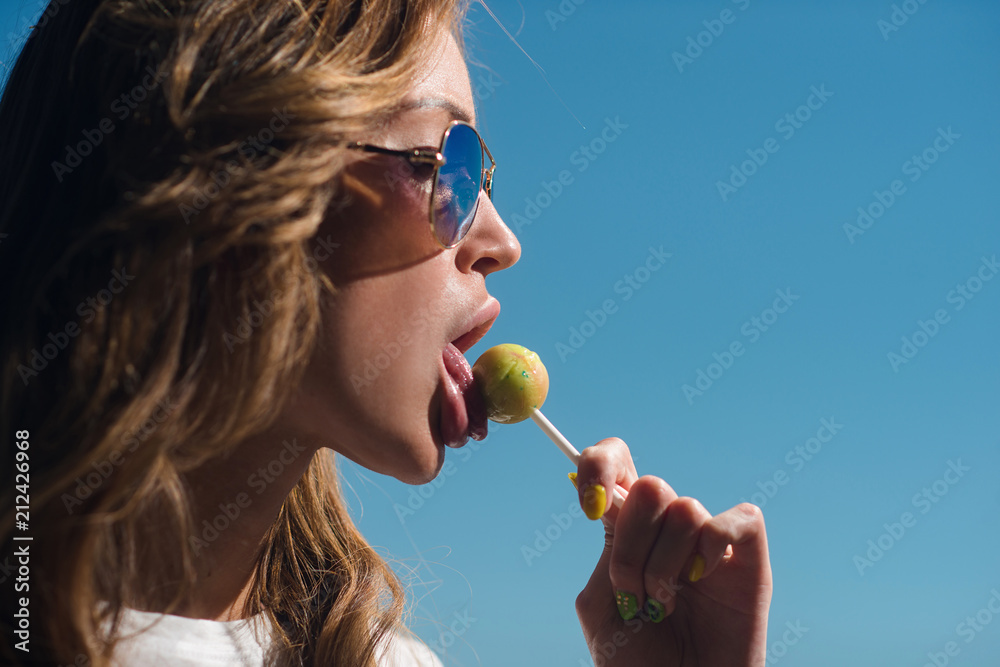 Beautiful girl sucks Lollipop in summer outdoors Beautiful girl sucks Lollipop in summer outdoors
