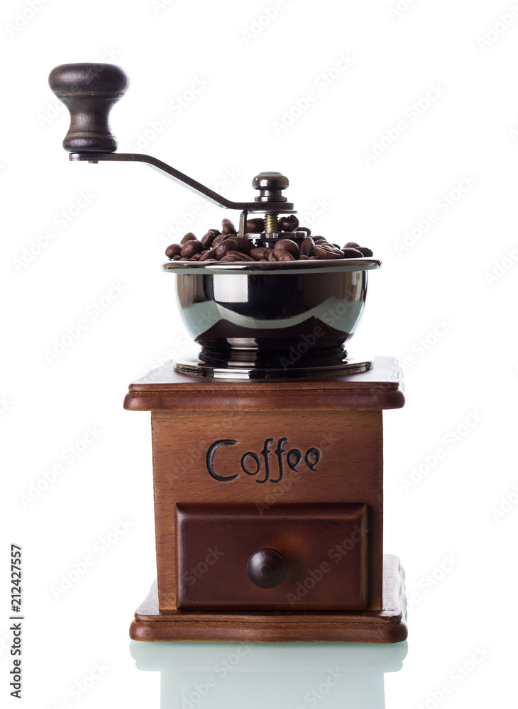 Hand coffee mill is full of grains isolated on white Hand coffee mill is full of grains isolated on white