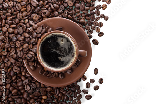 Scattered coffee beans and a Cup of coffee with foam isolated on white