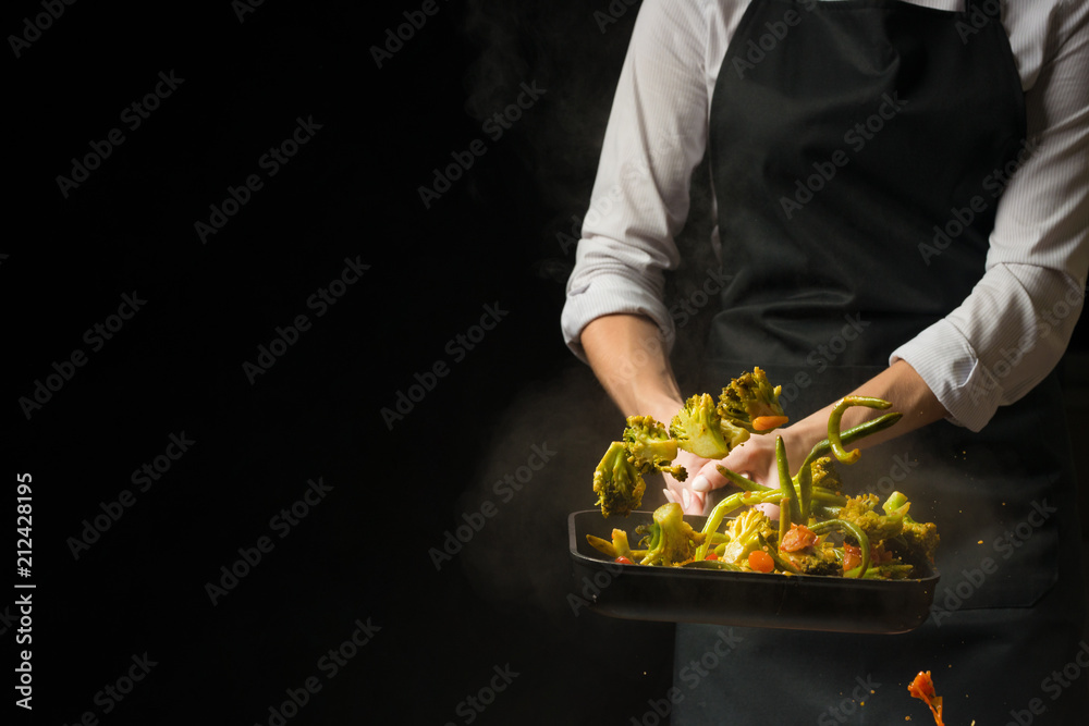 The chef prepares. Black background for copy text.Concept cooking