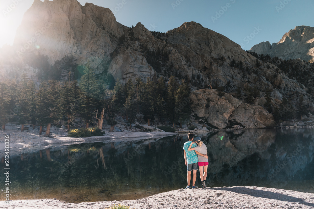 young couple in  Yosemite, USA: Mountain landscape with mirror lake surrounded by high peaks