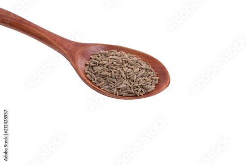 dry zira seeds spice in the spoon isolated on the white