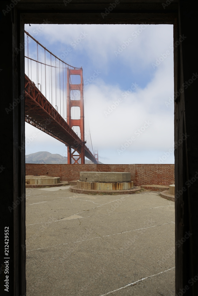 Cloudy midday in Golden Gate Bridge, seen from above of Fort Point. The Golden Gate Bridge is a famous suspension bridge connecting the American city of San Francisco, California to Marin County.
