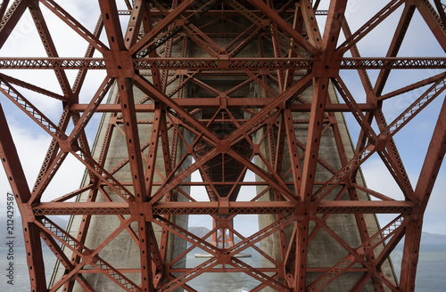 Structure detail the Fort Point arch of the Golden Gate Bridge. The Golden Gate Bridge is a famous suspension bridge connecting the American city of San Francisco, California to Marin County.