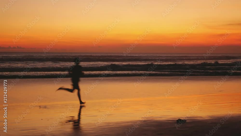 Silhouette of young man runs along the beach during amazing golden sunset. 3840x2160 Silhouette of young man runs along the beach during amazing golden sunset. 3840x2160