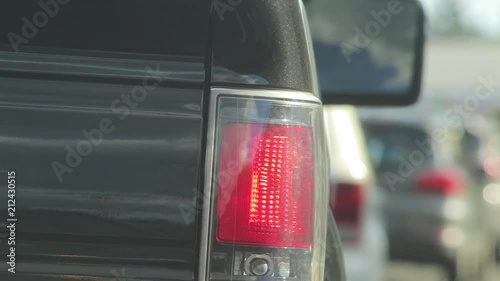 close up of the tail lights of a veicle at a stop light photo