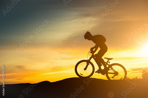 Fototapeta Naklejka Na Ścianę i Meble -  Extreme mountain bike sport athlete man riding outdoors lifestyle trail.