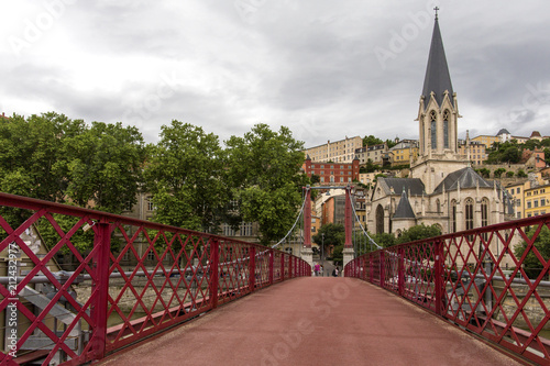 Church of Saint Georges and footbridge, Lyon, France. Panoramic view of Saint Georges church and pedestrian footbridge across Saone river, Old town with Fourviere cathedral..