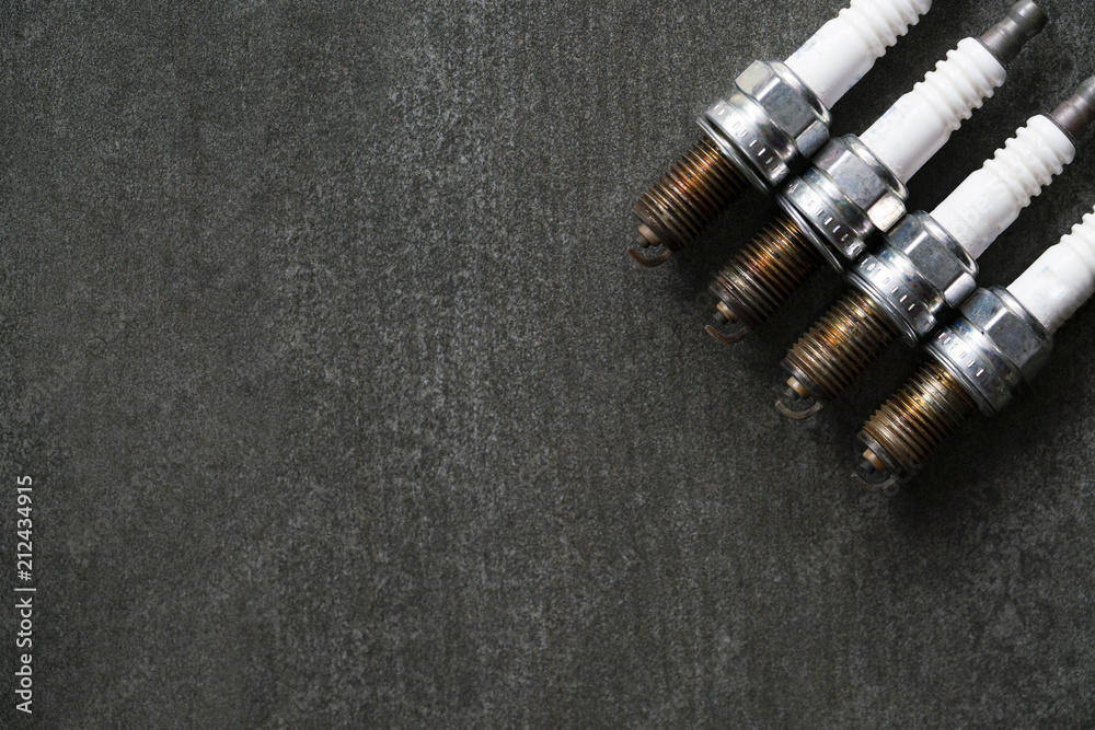 Old spark plugs on the black table Old spark plugs on the black table