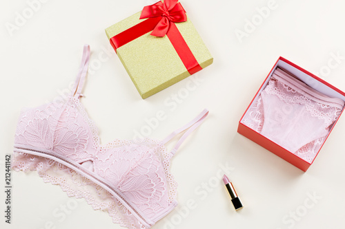 Woman elegant pink lace lingerie in open gift box, surprise concept.